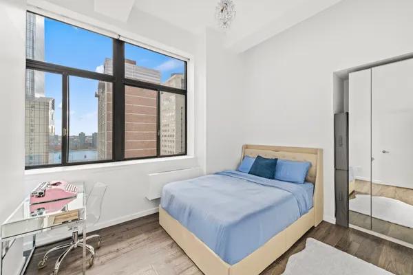 a bedroom with a bed and a window