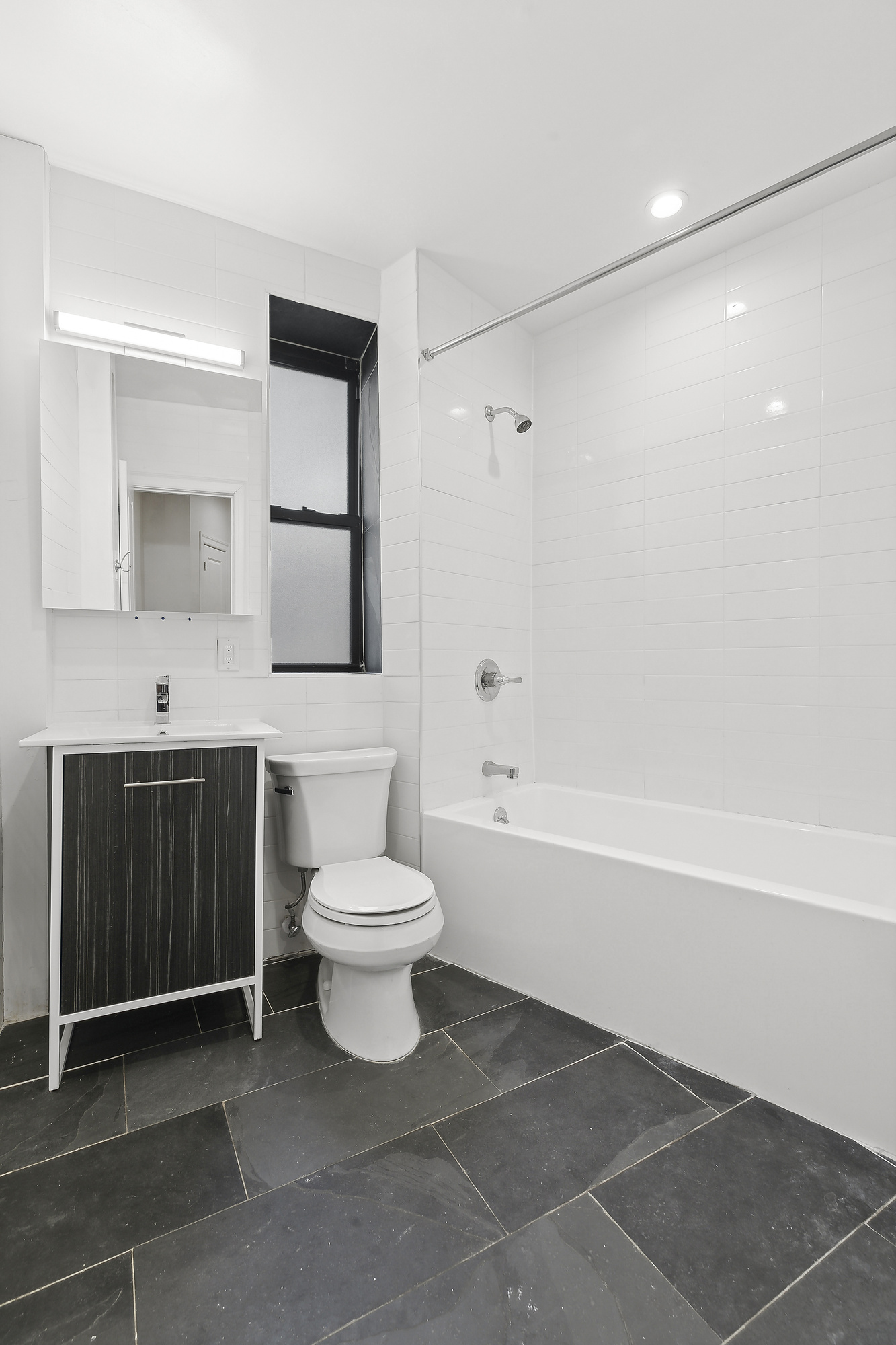 961 Washington Avenue, Unit 1I Brooklyn, NY 11225 - Photo 7 of 8 a bathroom with a toilet a sink and a bathtub