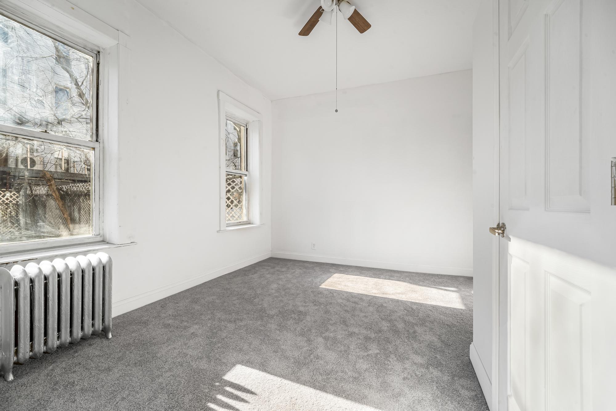 1384 Pacific Street, Unit A2 Brooklyn, NY 11216 - Photo 9 of 16 a view of an empty room with a window