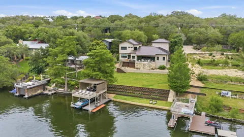 a aerial view of a house with a garden and swimming pool