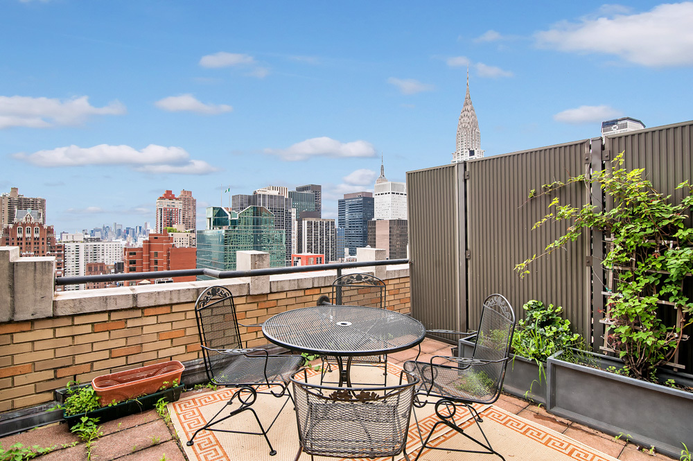 310 East 46th Street, Unit PHG Manhattan, NY 10017 - Photo 11 of 13 a view of a terrace with furniture and a potted plant