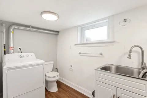 a bathroom with a toilet sink and mirror