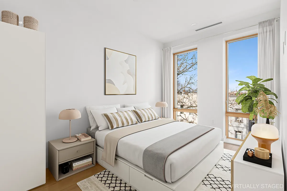 496 Wilson Avenue, Unit 4A Brooklyn, NY 11221 - Photo 4 of 10 a bedroom with a bed a couch and next to a window