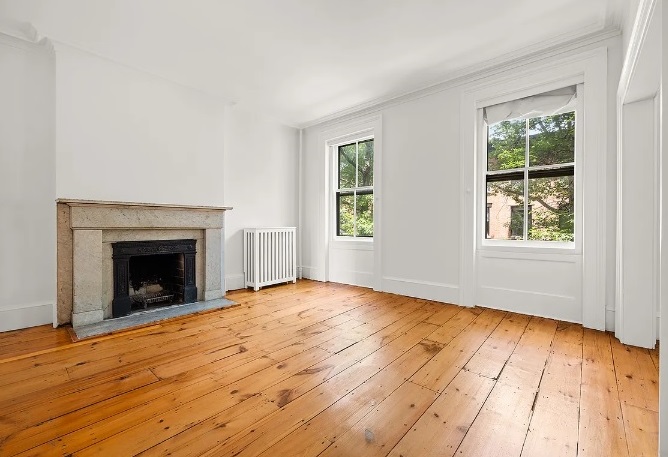 138 State Street Brooklyn, NY 11201 - Photo 6 of 13 a view of an empty room with wooden floor fireplace and a window