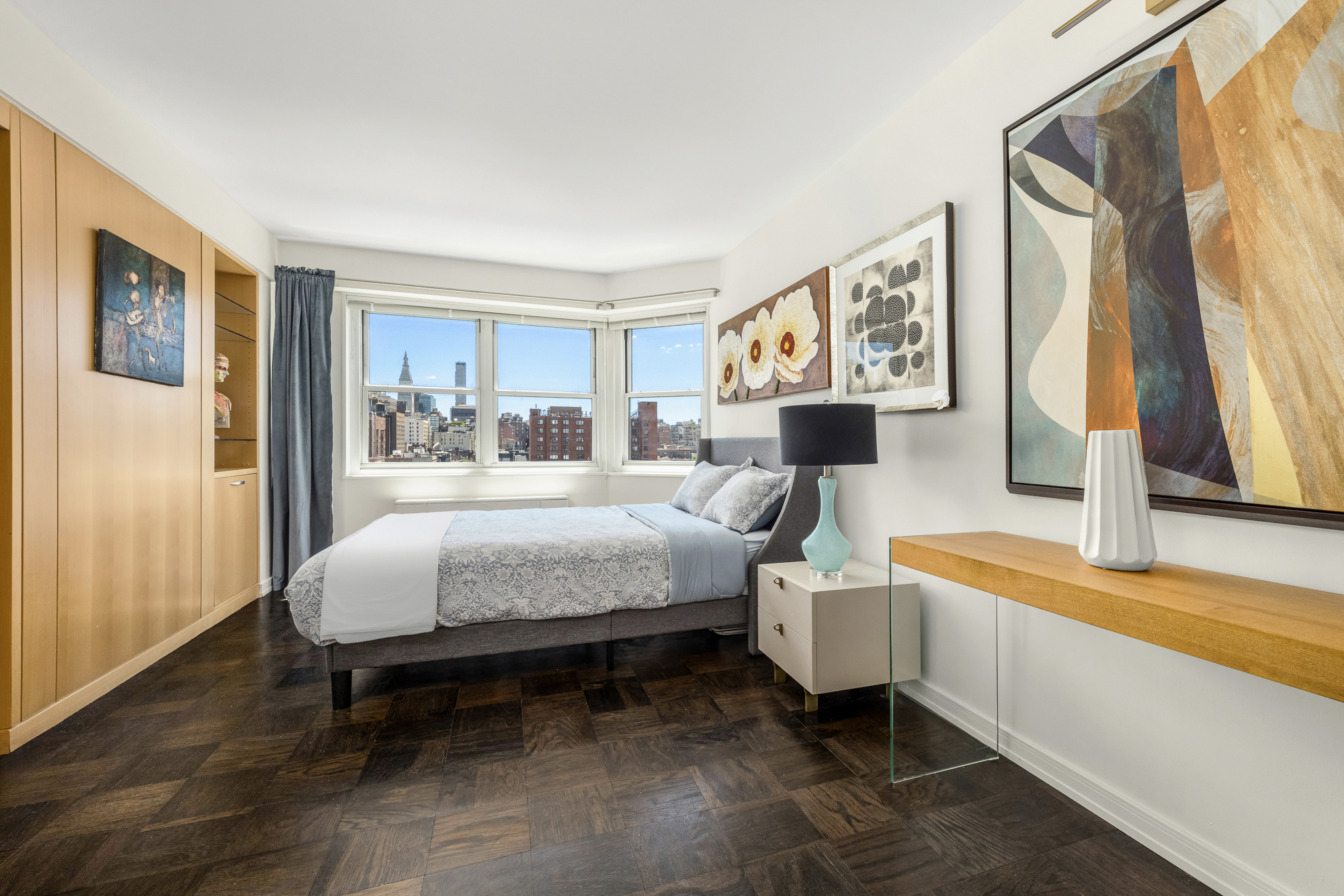 360 West 22nd Street, Unit 12L Manhattan, NY 10011 - Photo 10 of 21 a bedroom with a bed and a flat screen tv