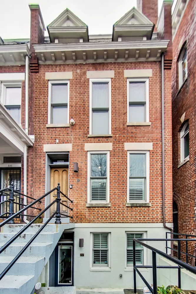 a front view of a residential apartment building with a yard