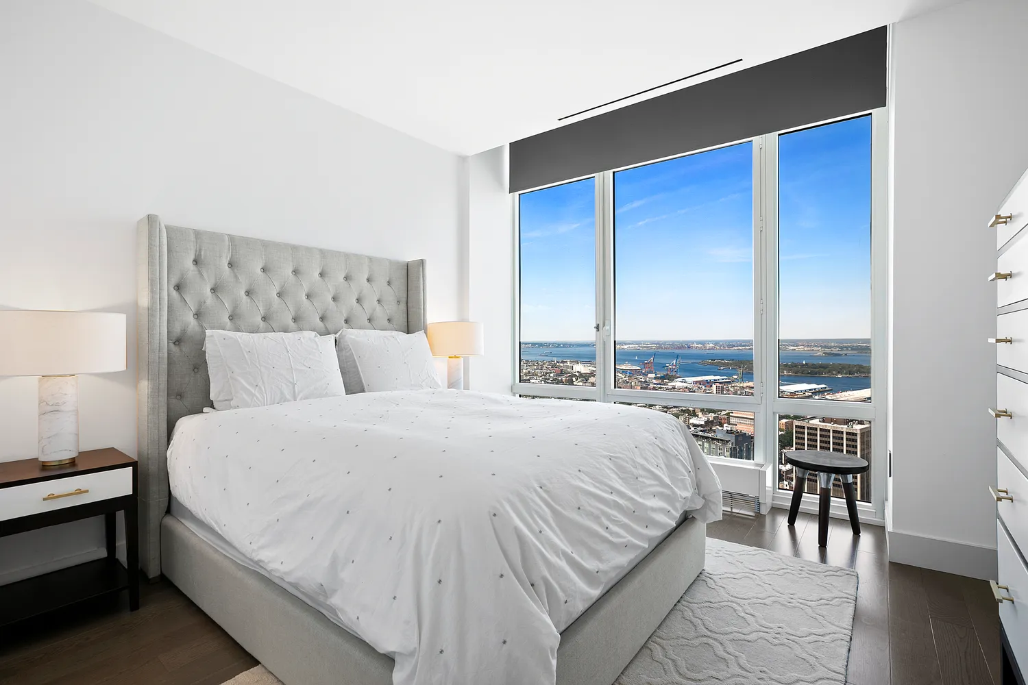 a bedroom with a bed and a large window
