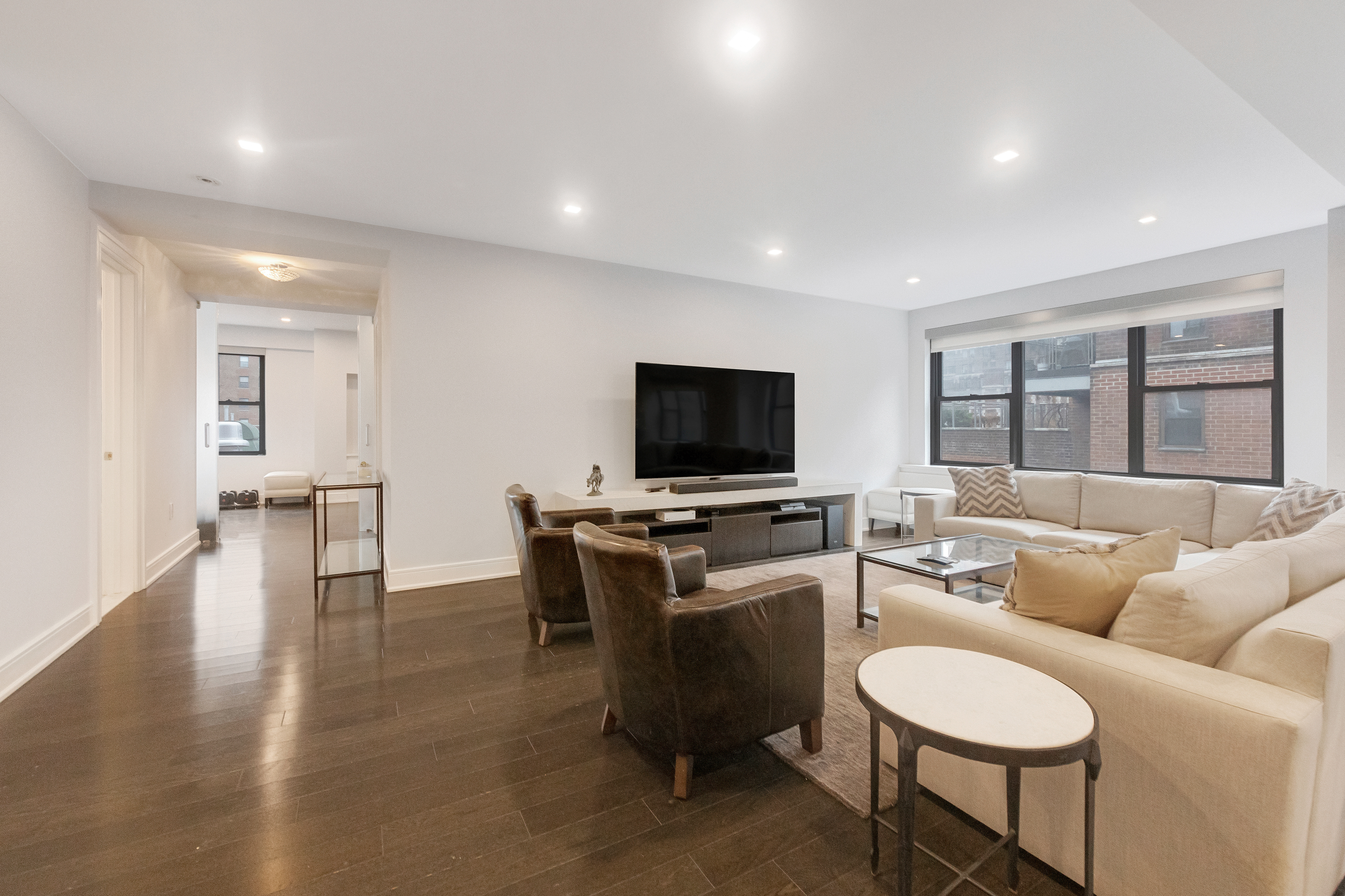2 Tudor City Place, Unit 12DS Manhattan, NY 10017 - Photo 3 of 20 a living room with furniture and a flat screen tv