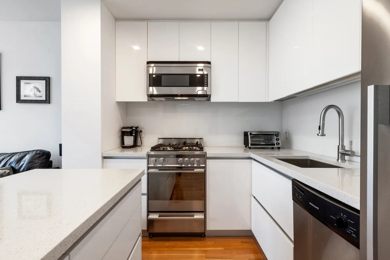 a kitchen with stainless steel appliances a sink stove and cabinets