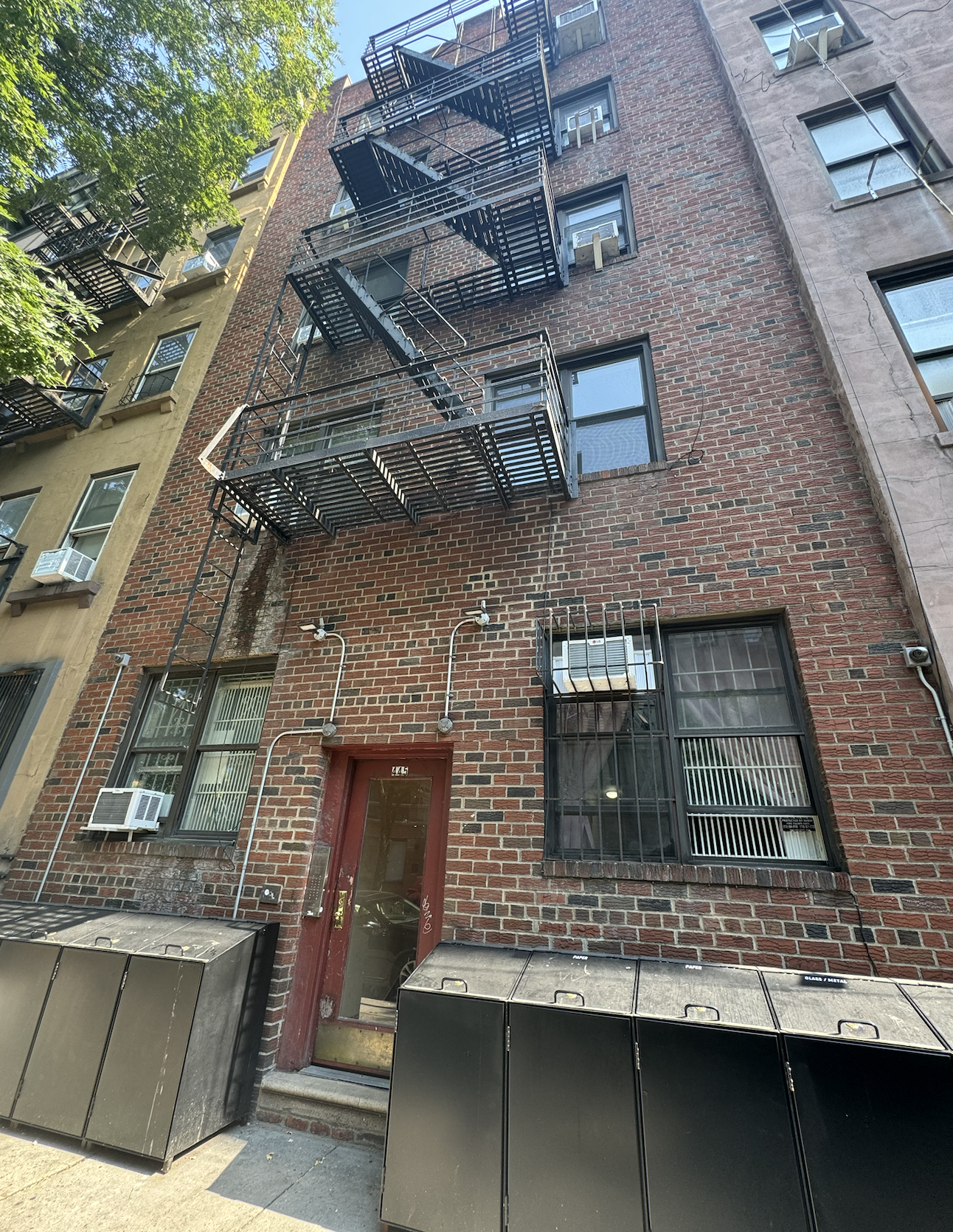 445 West 48th Street, Unit 2D Manhattan, NY 10036 - Photo 11 of 18 a front view of a building with a tree