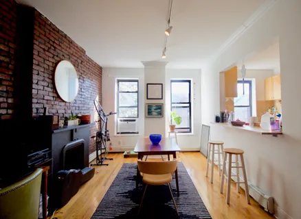 a living room with fireplace furniture and a large window