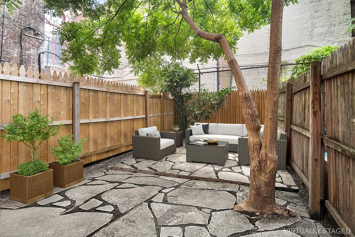 147 Sullivan Street, Unit 1A Manhattan, NY 10012 - Photo 2 of 6 a view of backyard with outdoor seating and plants