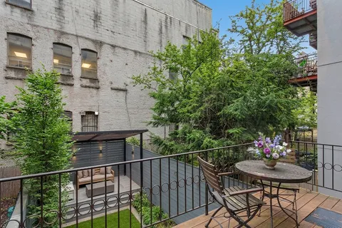 a balcony with table and chairs