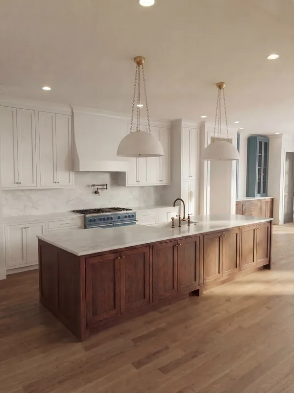 a kitchen with kitchen island granite countertop a sink cabinets and wooden floor