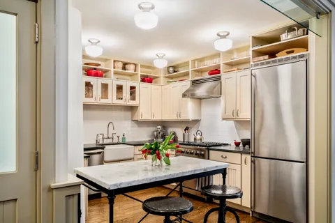 a kitchen with refrigerator cabinets and wooden floor