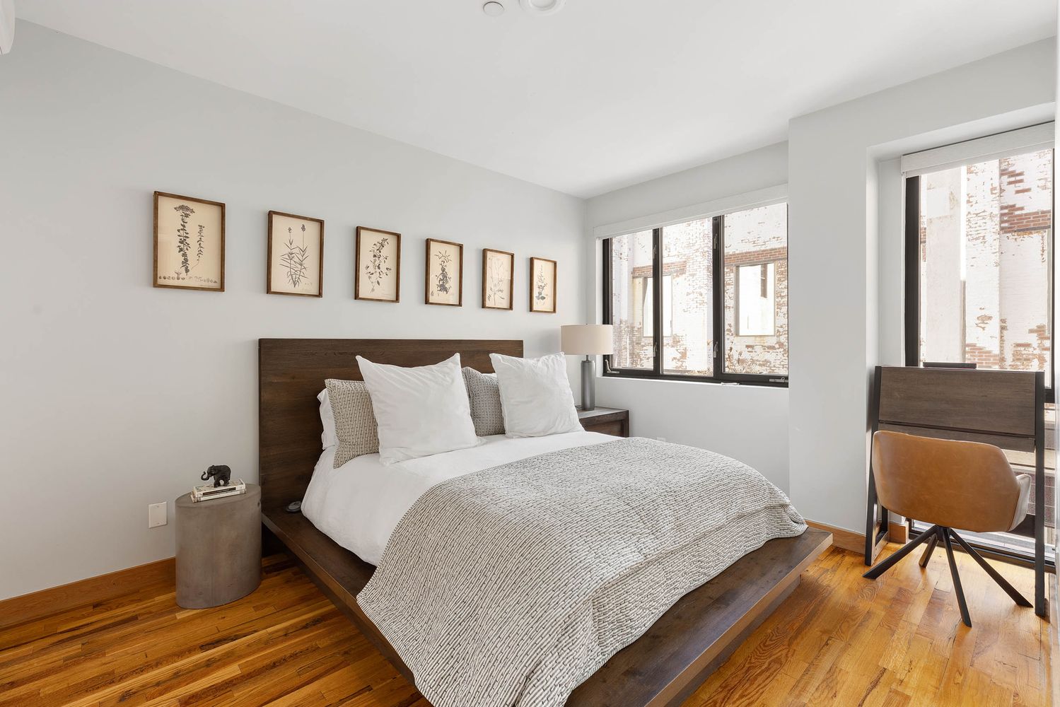 a bedroom with a bed and a dresser next to a window