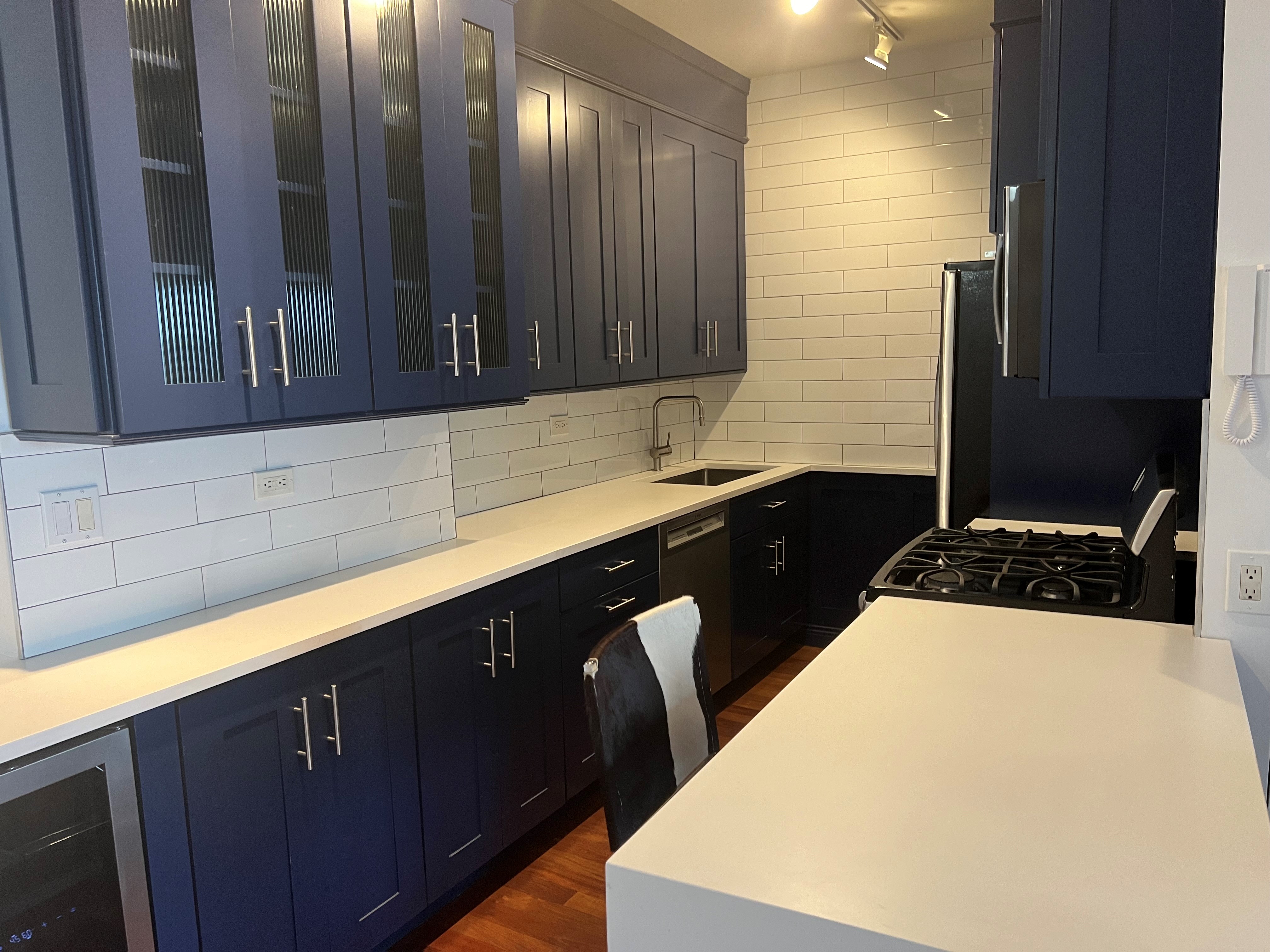 60 East 8th Street, Unit 23D Manhattan, NY 10003 - Photo 6 of 16 a kitchen with a sink and a refrigerator