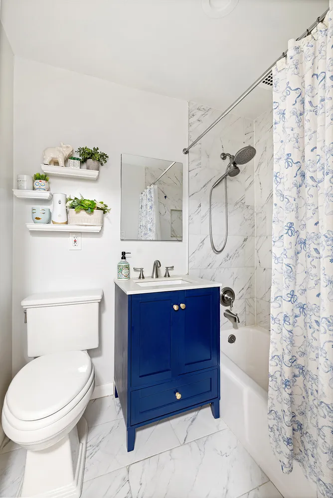 a bathroom with a sink vanity mirror and toilet