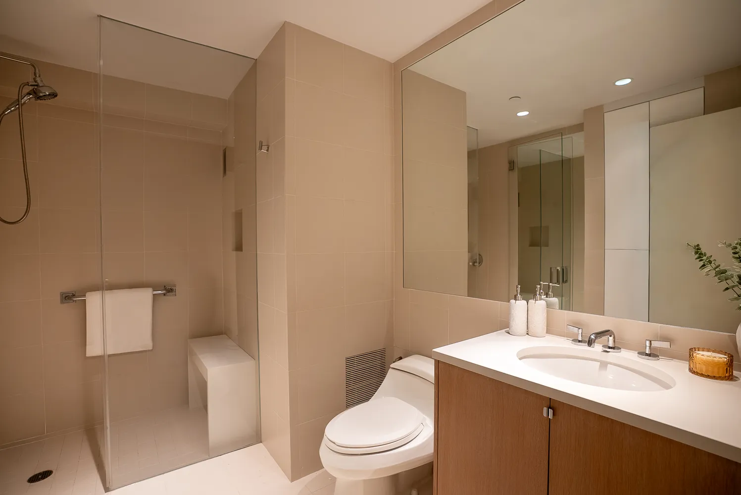 a bathroom with a sink toilet vanity and shower