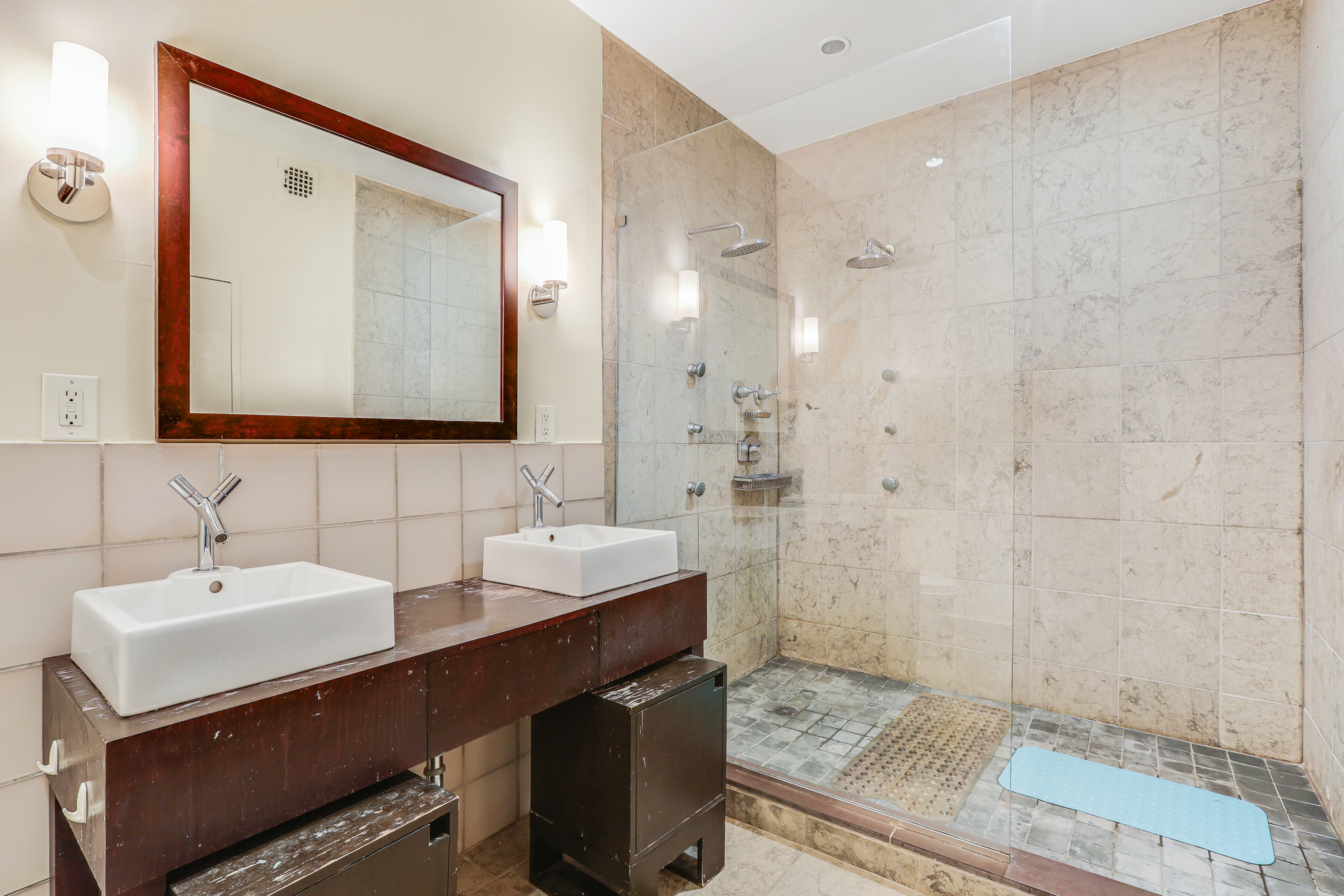 136-140 West 23rd Street, Unit 4C Manhattan, NY 10011 - Photo 9 of 12 a bathroom with double sink and a mirror