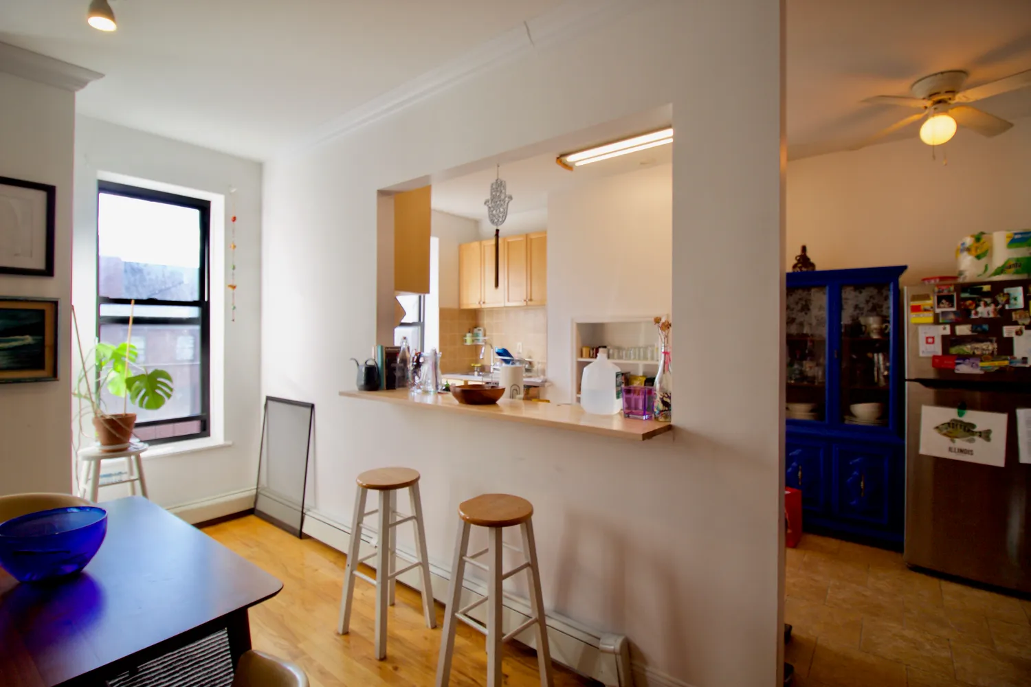 a view of a dining room with furniture and a window