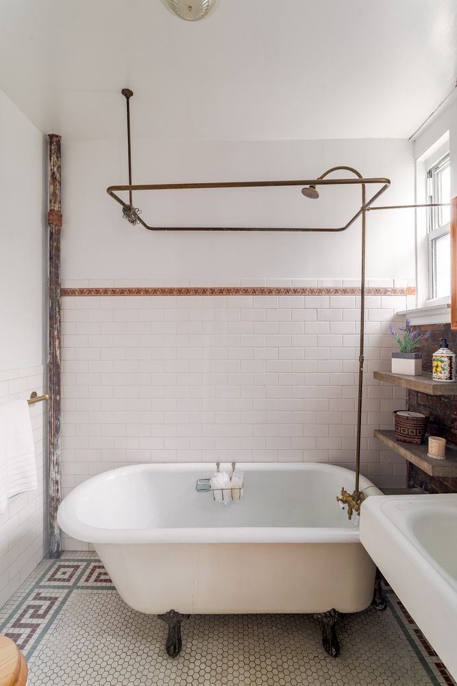 a bathroom with a white bathtub and a shower