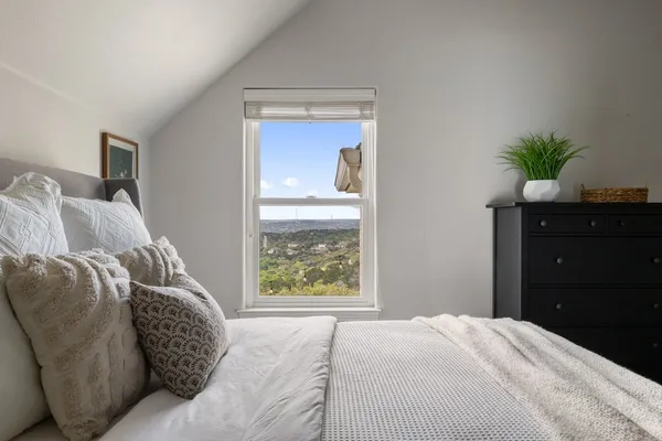 a bed sitting in a bedroom next to a window