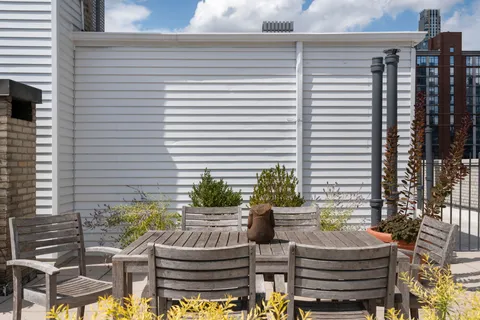 a view of a patio with couches chairs and potted plants