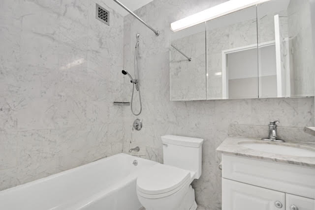 30 West 63rd Street, Unit 7O Manhattan, NY 10023 - Photo 4 of 16 a bathroom with a granite countertop sink a toilet and shower