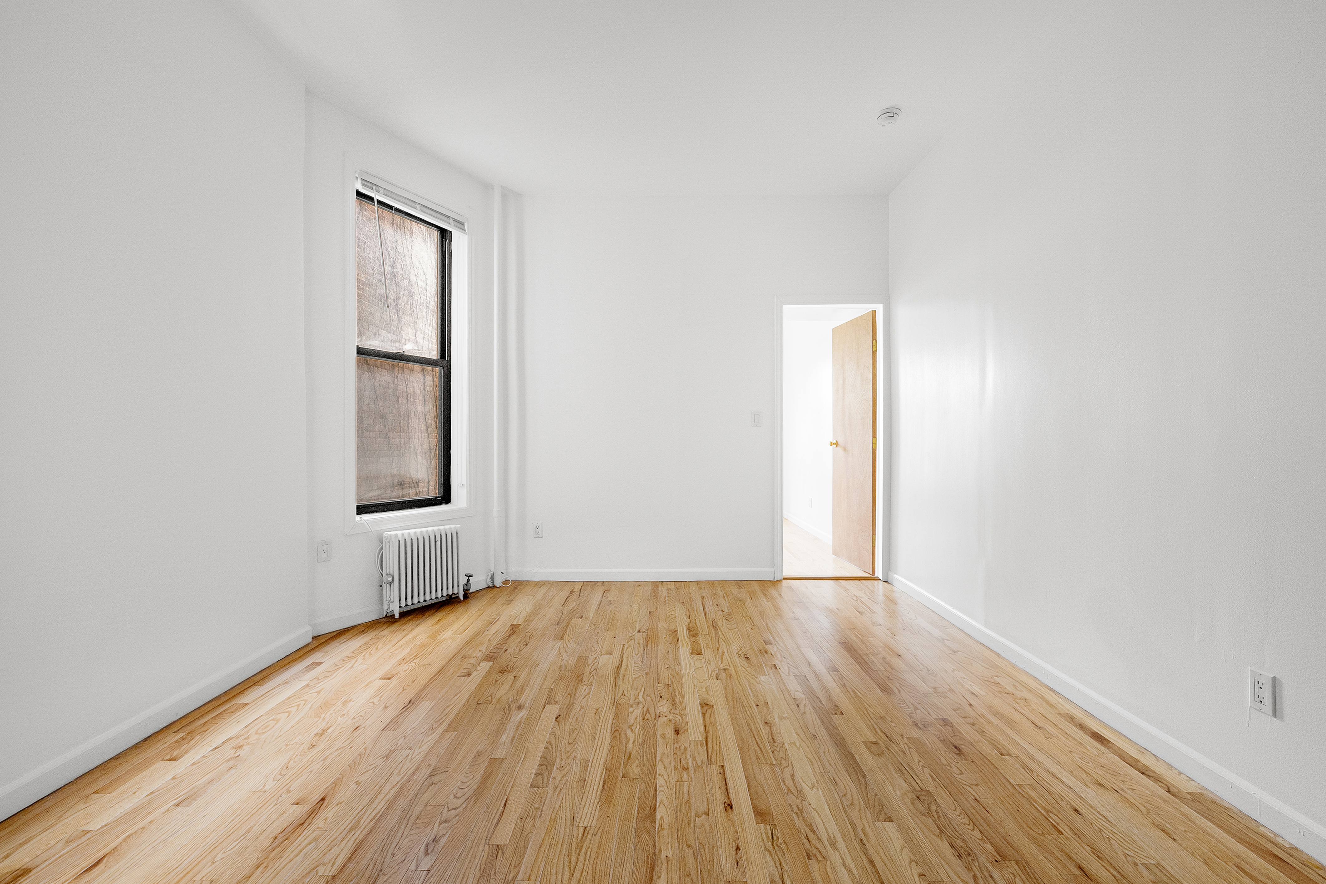 325 3rd Street, Unit 2A Brooklyn, NY 11215 - Photo 7 of 13 an empty room with wooden floor and windows