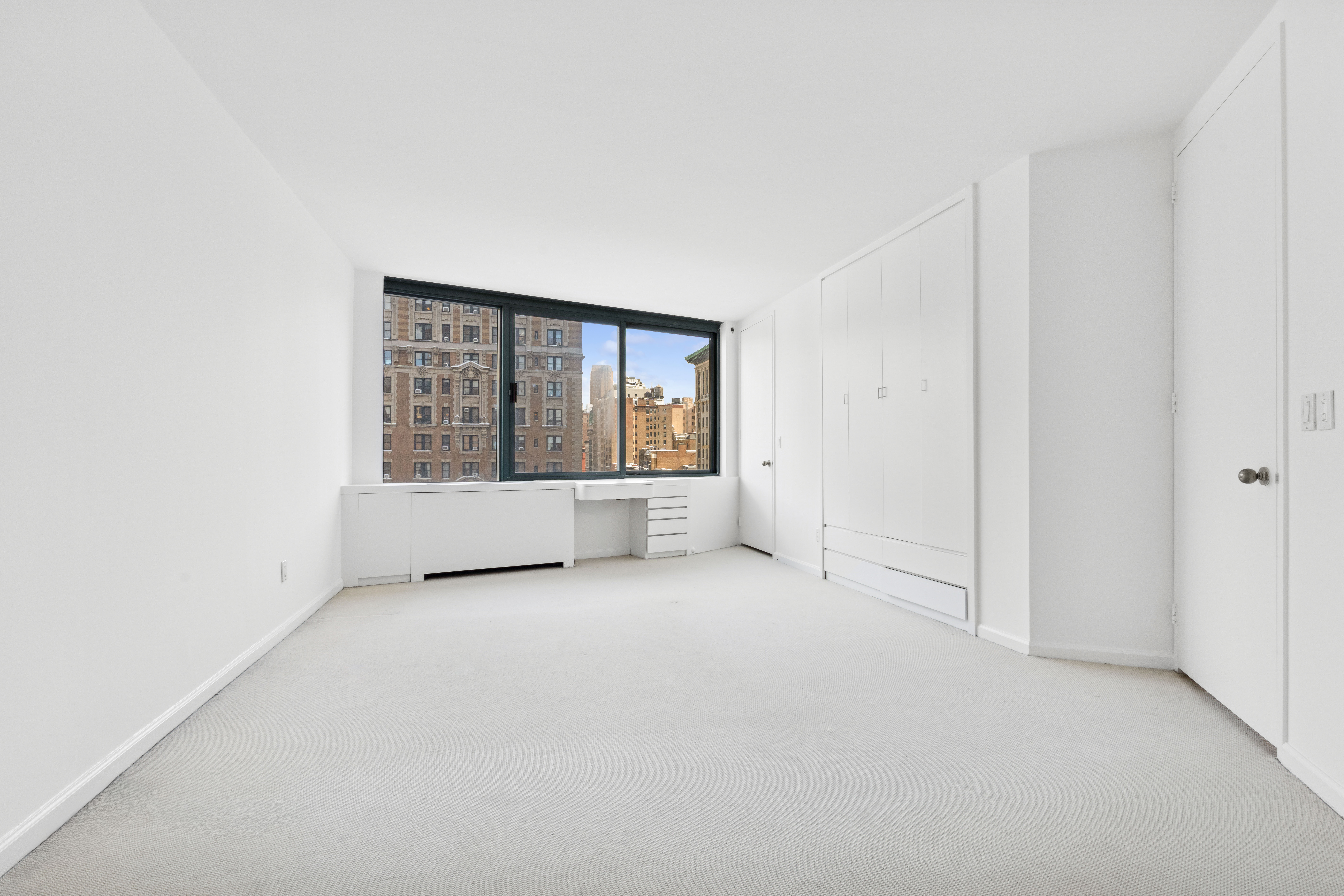 201 West 72nd Street, Unit 8A Manhattan, NY 10023 - Photo 7 of 15 an empty room with windows