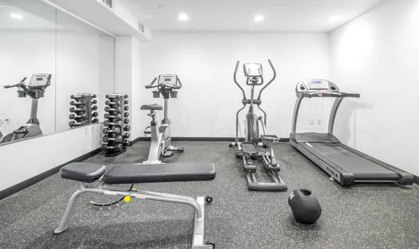 a room with gym equipment and view of living room