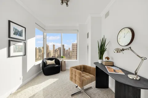 a living room with furniture a large window with wooden floor