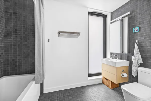 a bathroom with a sink a toilet and bathtub