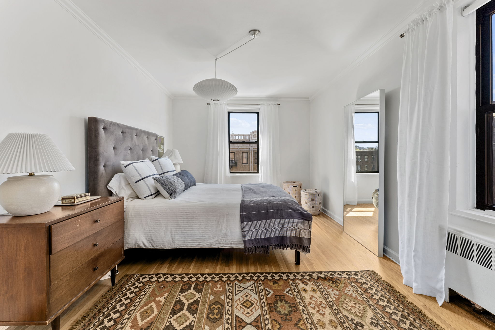 675 Academy Street, Unit 5E Manhattan, NY 10034 - Photo 7 of 10 a bedroom with a bed and wooden floor