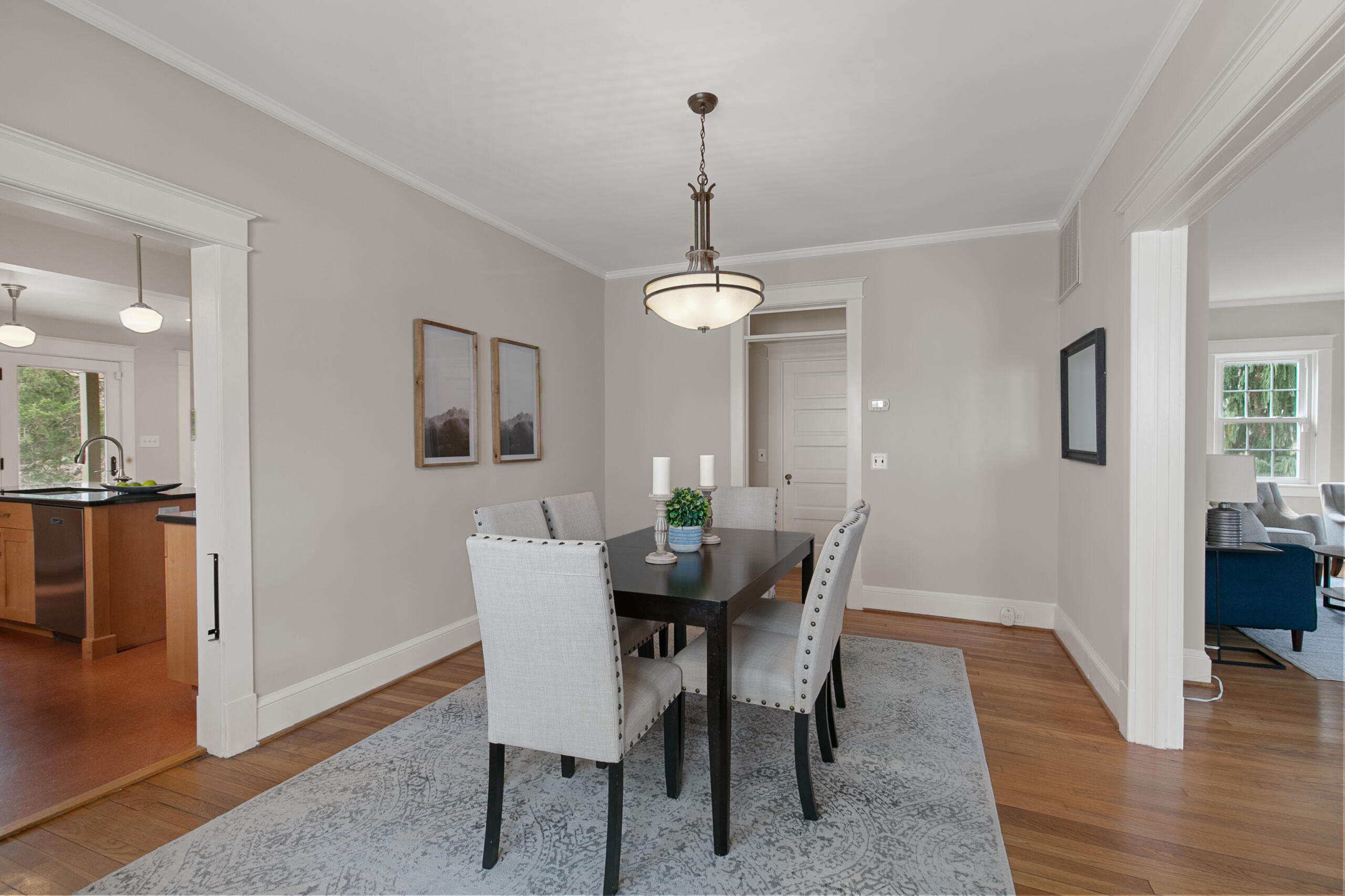 1908 Glen Ross Road Silver Spring, MD 20910 - Photo 14 of 63 a dining room with furniture wooden floor a rug a potted plant a fireplace and a chandelier