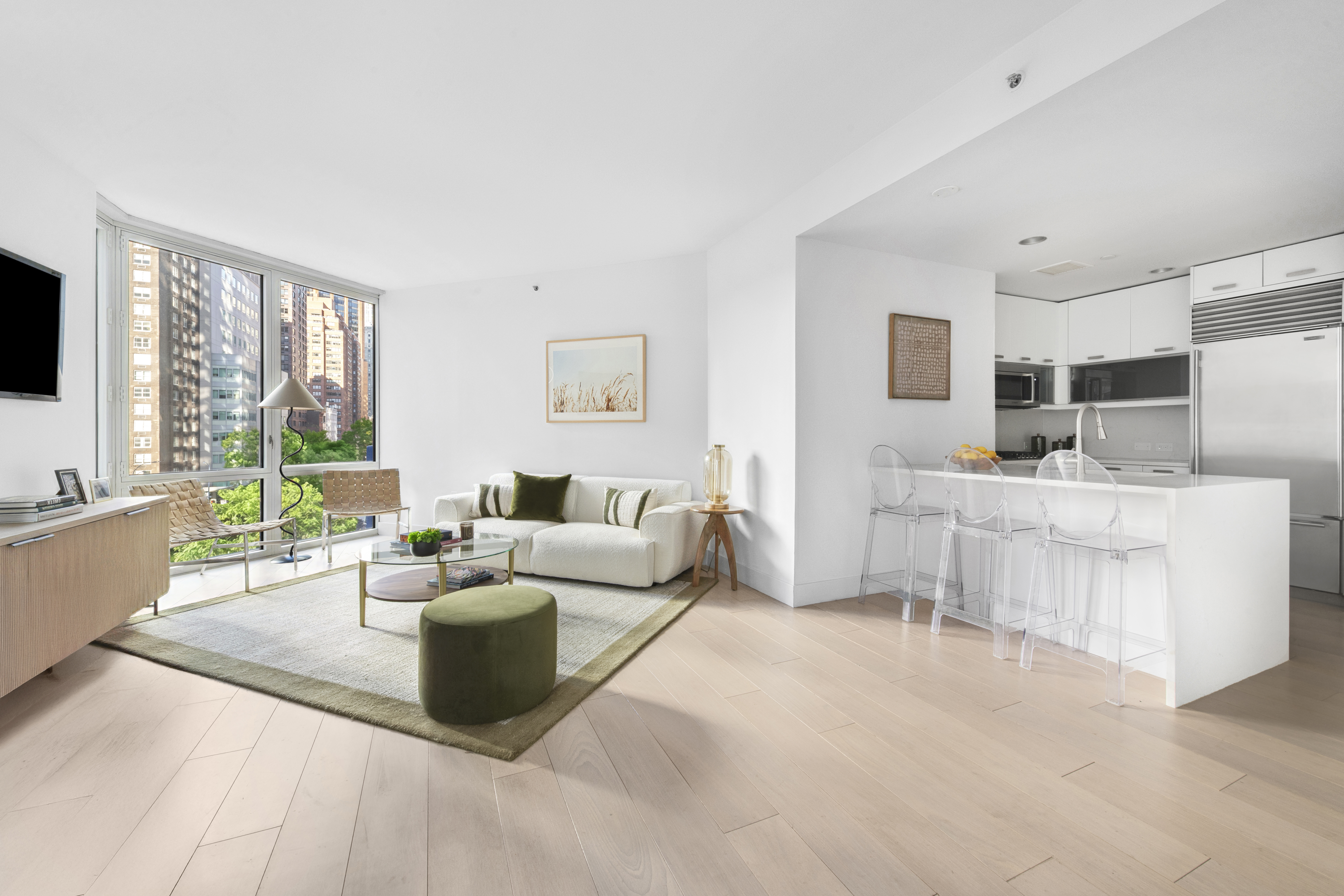 225 East 34th Street, Unit 5E Manhattan, NY 10016 - Photo 2 of 23 a living room with furniture and a flat screen tv