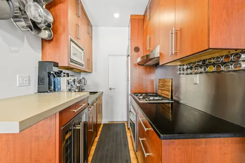 a kitchen with stainless steel appliances granite countertop a sink a stove and a refrigerator
