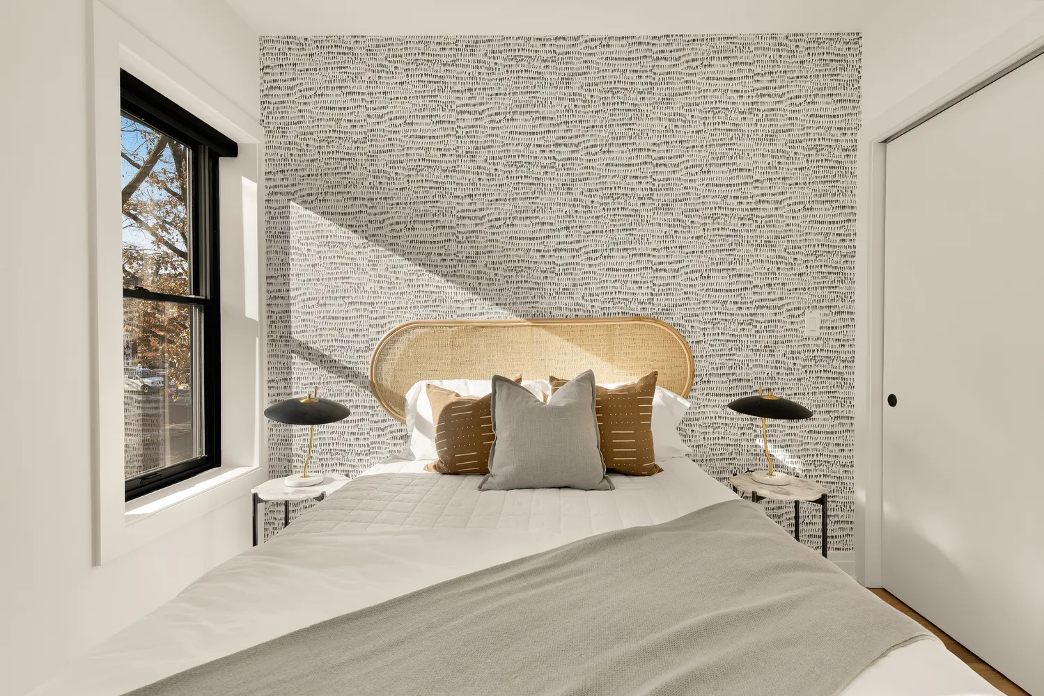 a bedroom with a bed and a mirror