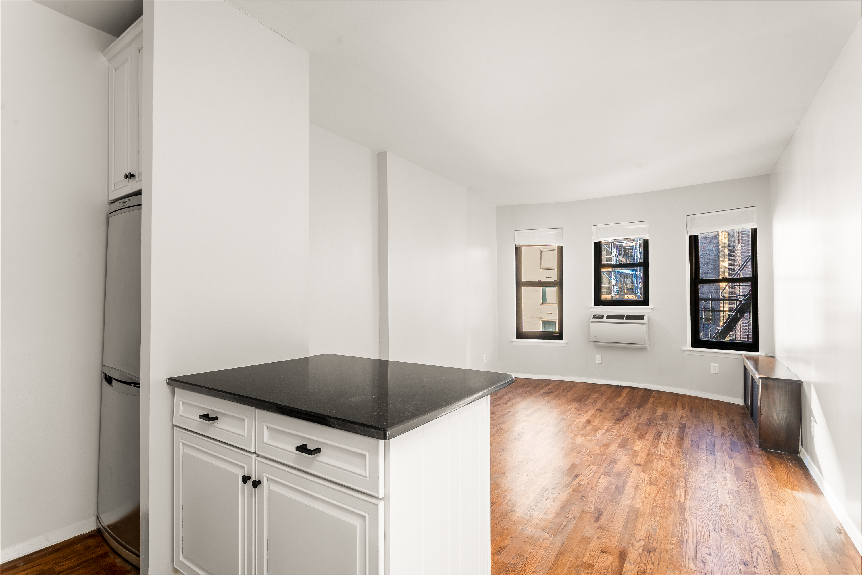 160 East 91st Street, Unit 7N Manhattan, NY 10128 - Photo 8 of 13 a kitchen with granite countertop a stove and a refrigerator