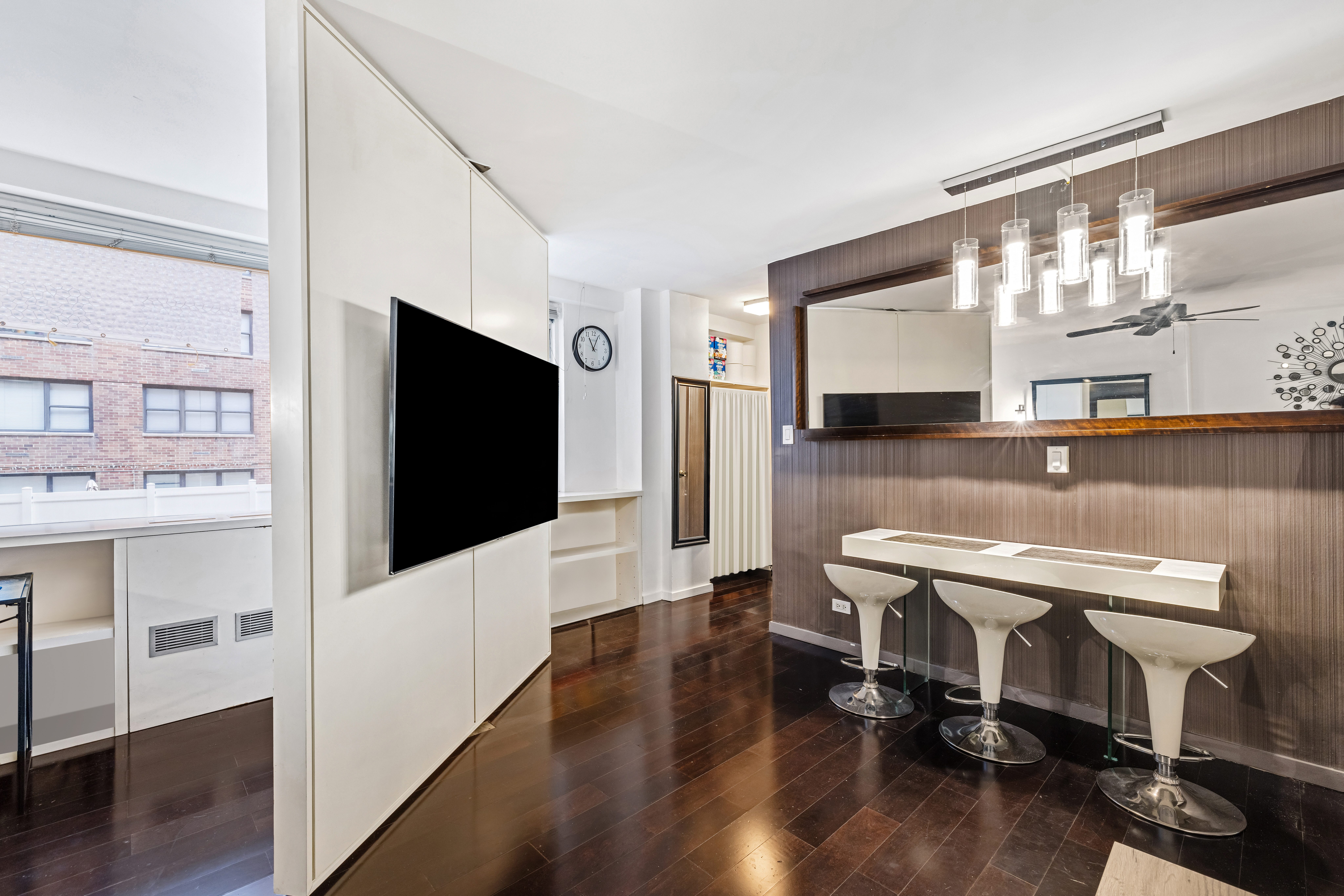 139 East 33rd Street, Unit 3M Manhattan, NY 10016 - Photo 2 of 11 a living room with furniture and a flat screen tv