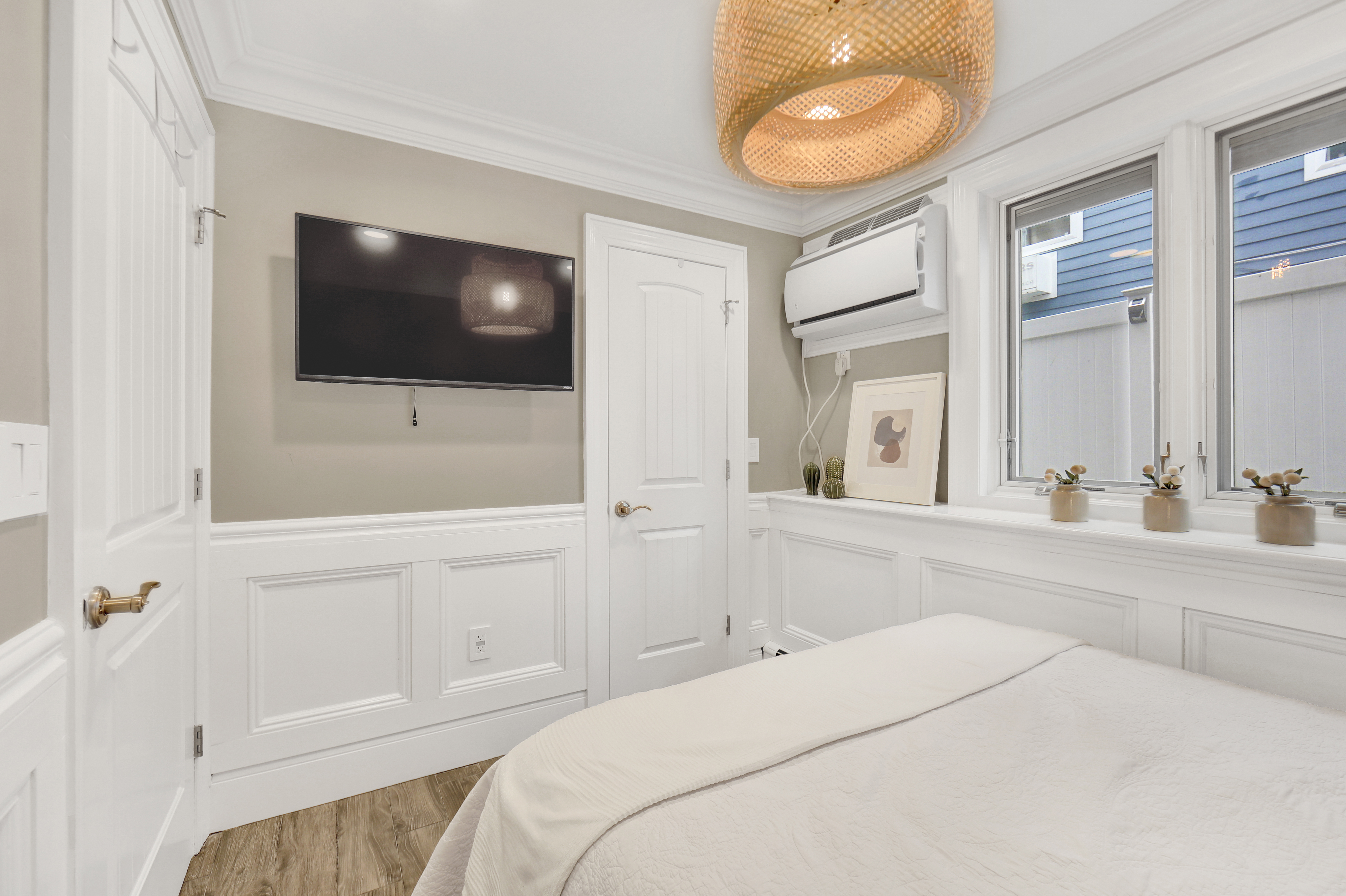 1-69 Beach 98th Street, Unit 1 Queens, NY 11694 - Photo 15 of 23 a bedroom with a large bed and a flat screen tv