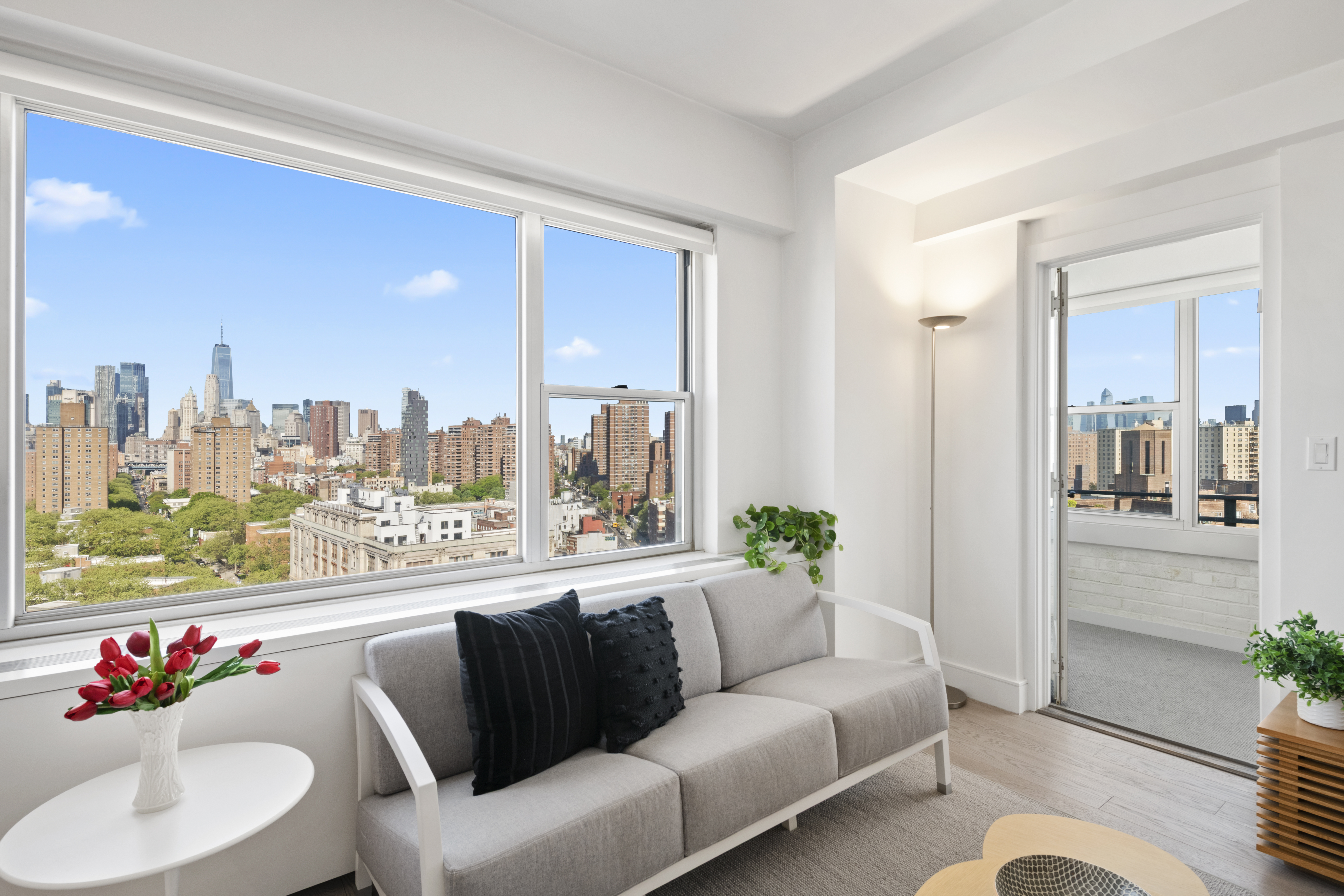 573 Grand Street, Unit D1707/1801 Manhattan, NY 10002 - Photo 4 of 24 a living room with furniture and a large window