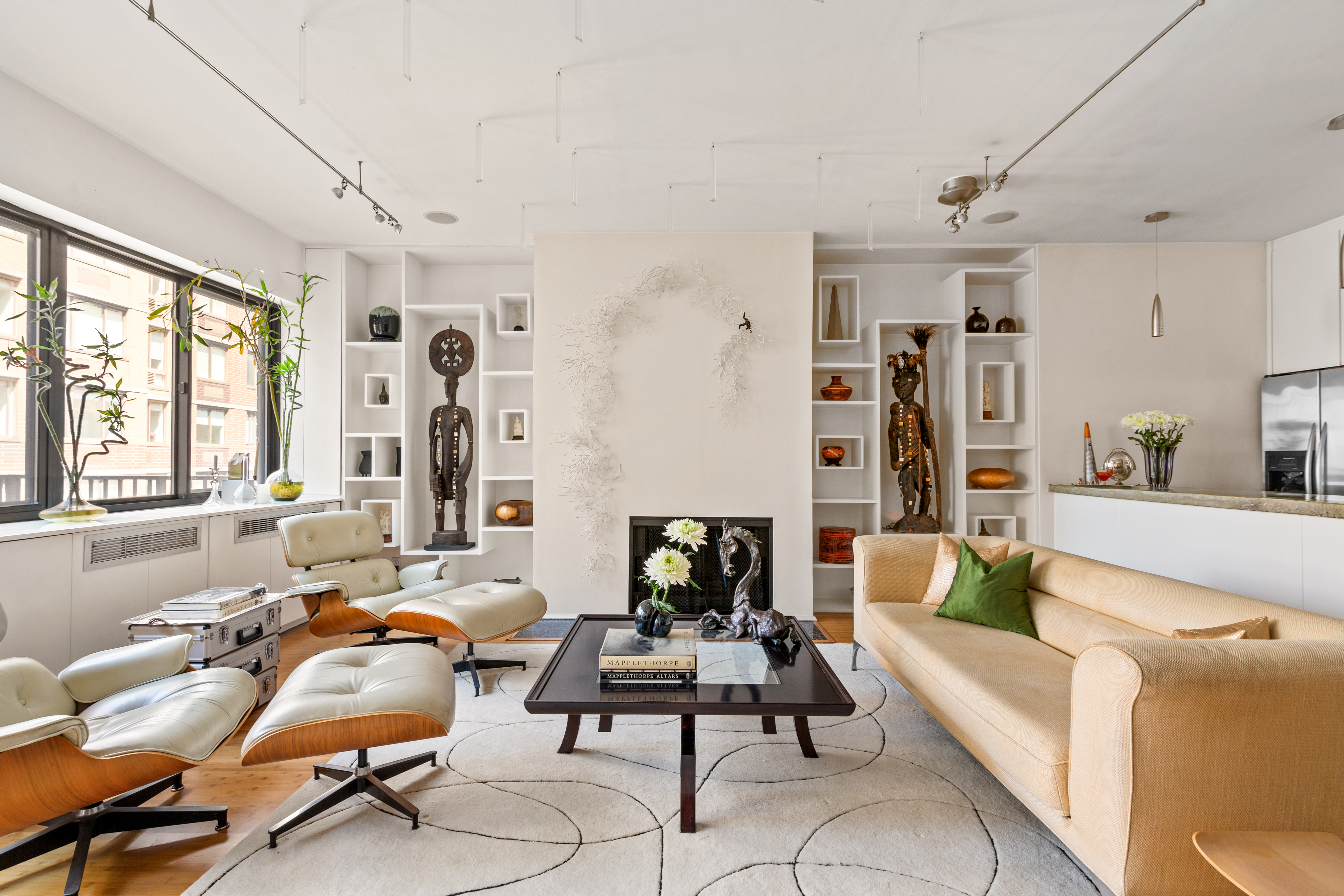 a living room with furniture and large windows
