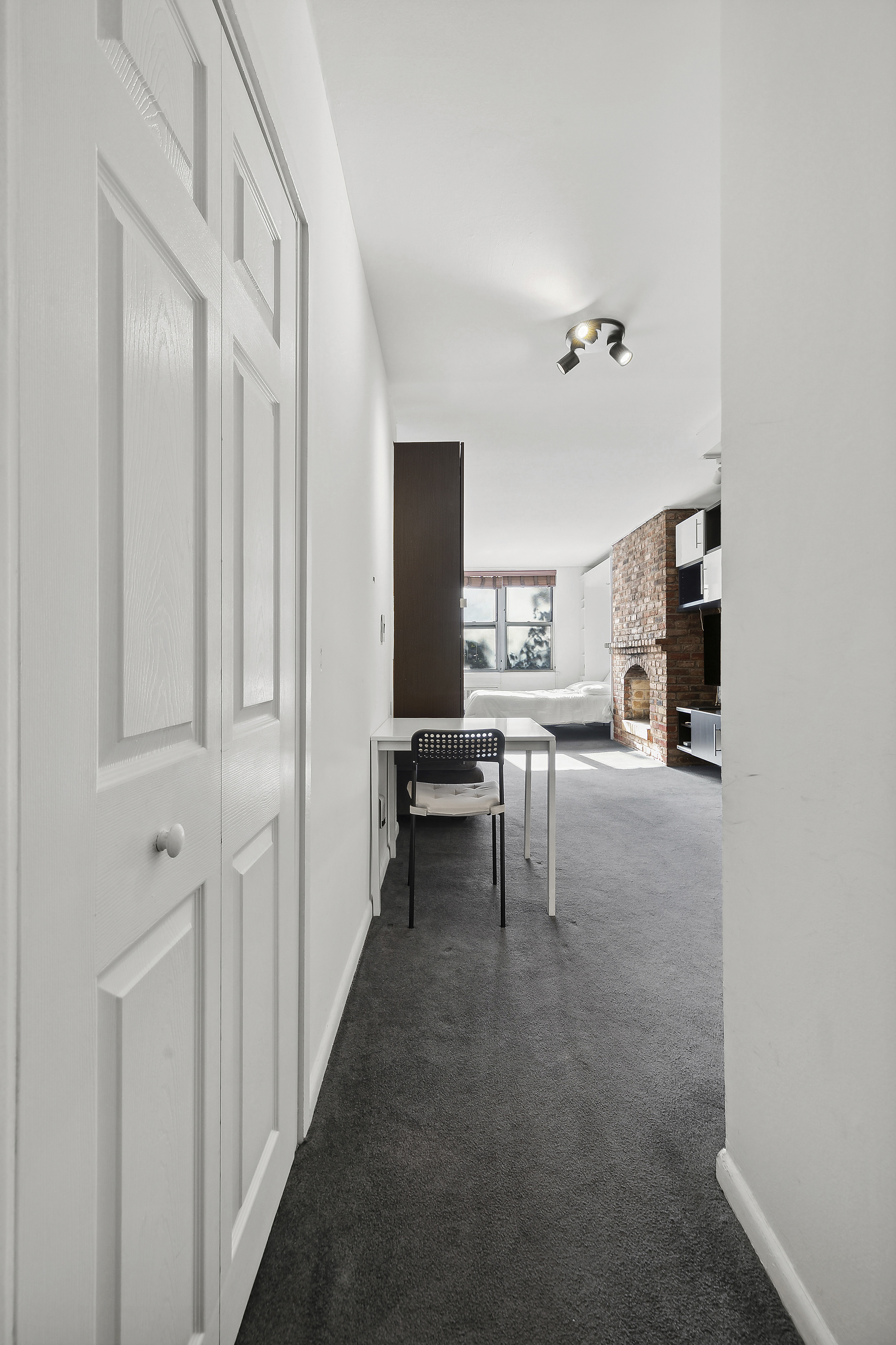 314 West 56th Street, Unit 4E Manhattan, NY 10019 - Photo 9 of 11 a view of living room with furniture and a window