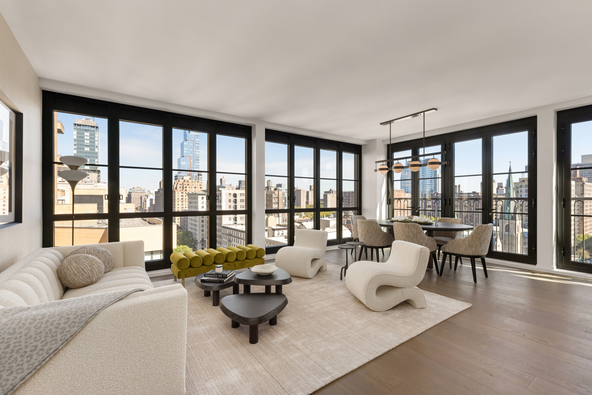 a living room with furniture and floor to ceiling windows