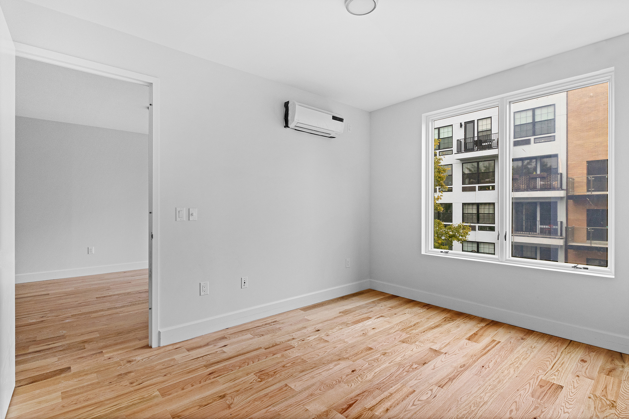 1098 Madison Street, Unit 4B Brooklyn, NY 11221 - Photo 6 of 11 a view of empty room with wooden floor and fan