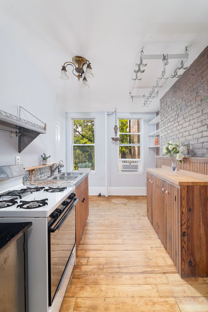 a kitchen with stainless steel appliances granite countertop a stove and a sink