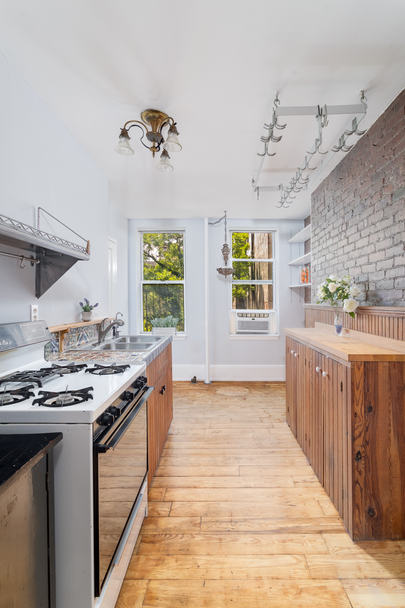 616 East 9th Street, Unit 4W Manhattan, NY 10009 - Photo 8 of 20 a kitchen with stainless steel appliances granite countertop a stove and a sink