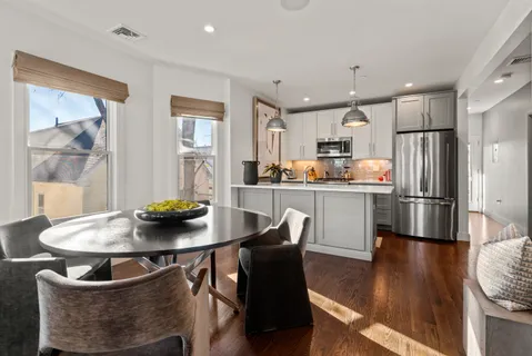 a kitchen with a dining table and chairs